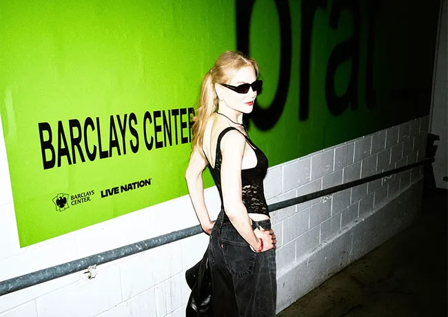 Nicole Kidman in front of Brat sign