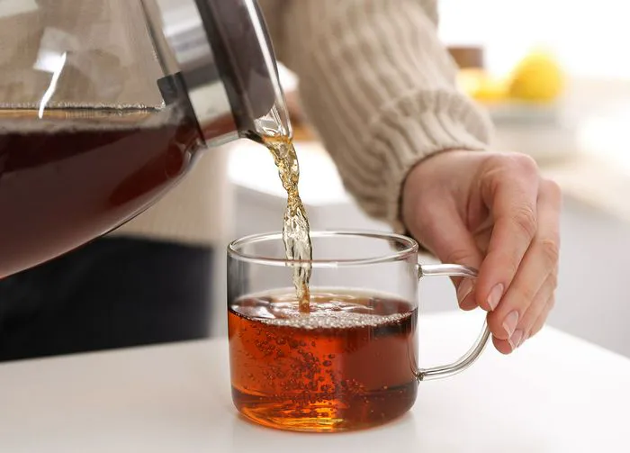black tea pouring into mug