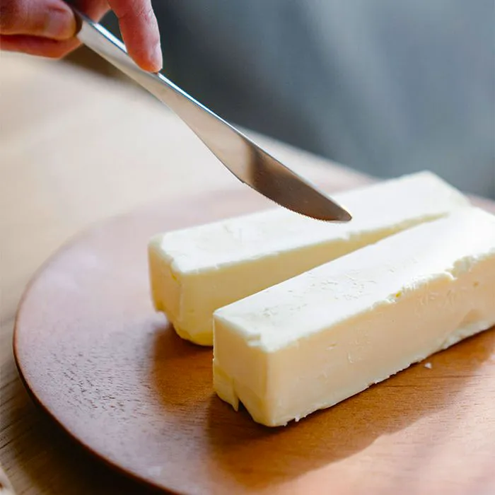 knives cutting into butter