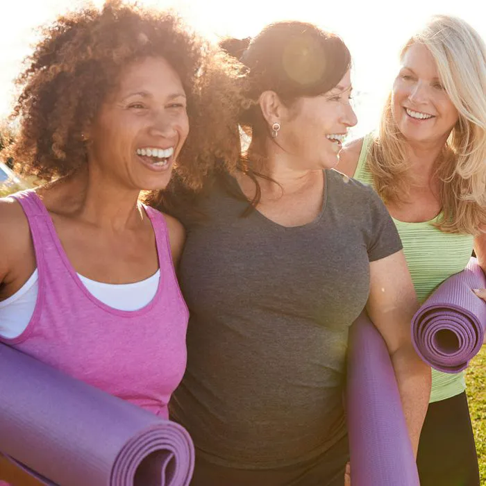 group of women with exercise mats