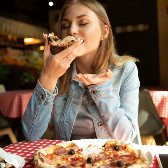 woman enjoying pizza