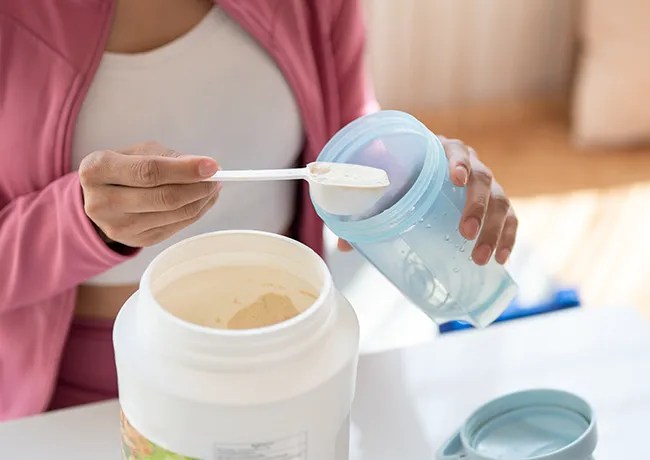 woman making a protein shake