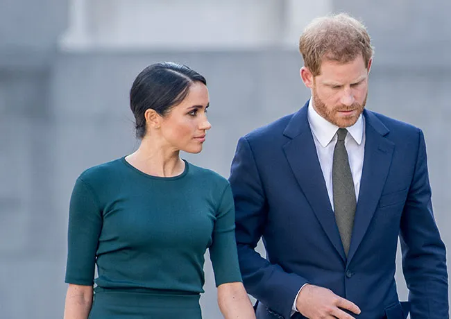 Prince Harry and Meghan Markle wearing blue