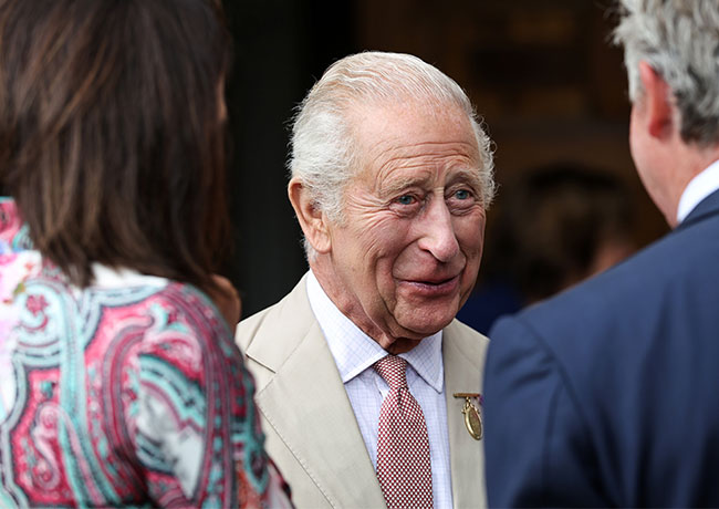 King Charles speaks with members of staff and club members of Jockey Club Rooms