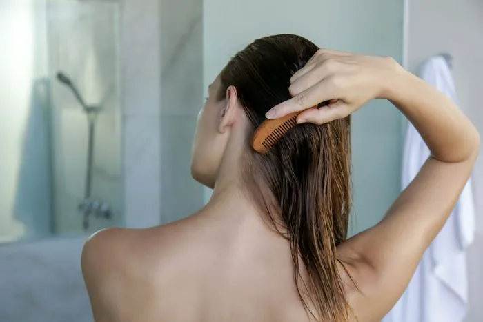 "Hairstylist cutting hair in salon"