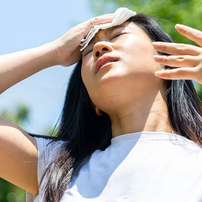 "Woman sweating outside after a workout"