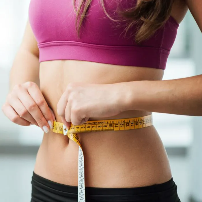 woman measuring waist
