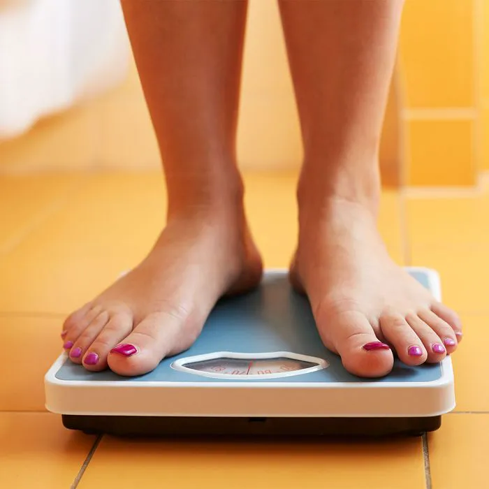 woman standing on scale