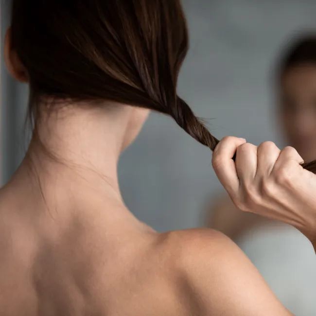 Woman showcasing hair services at a salon