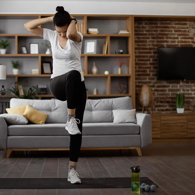 Woman performing standing crunches for abdominal strength