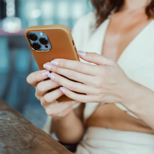 "Stylish woman texting on her iPhone"