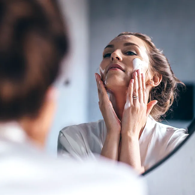 woman cleansing face