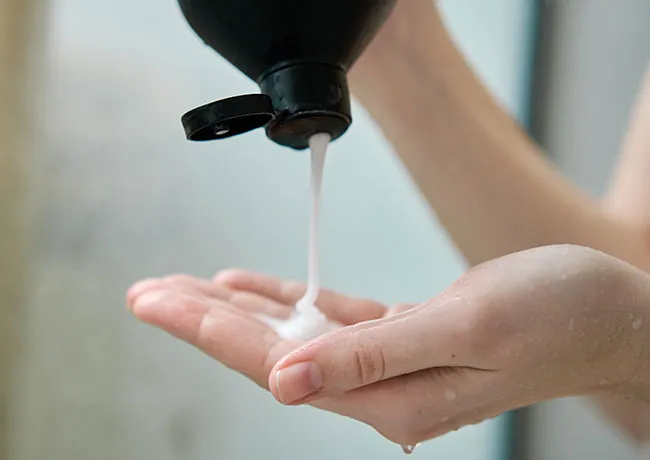 woman-squeezing-shampoo-hand