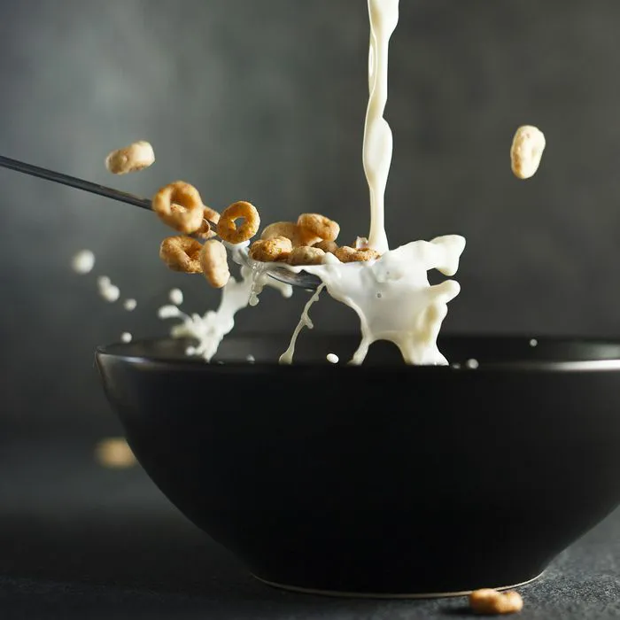 milk pouring into cereal bowl