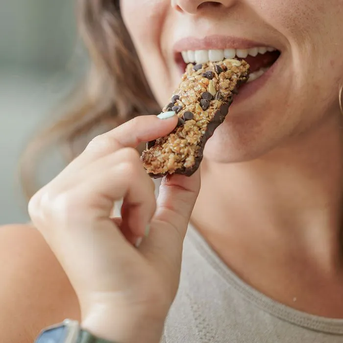 woman eating granola bar