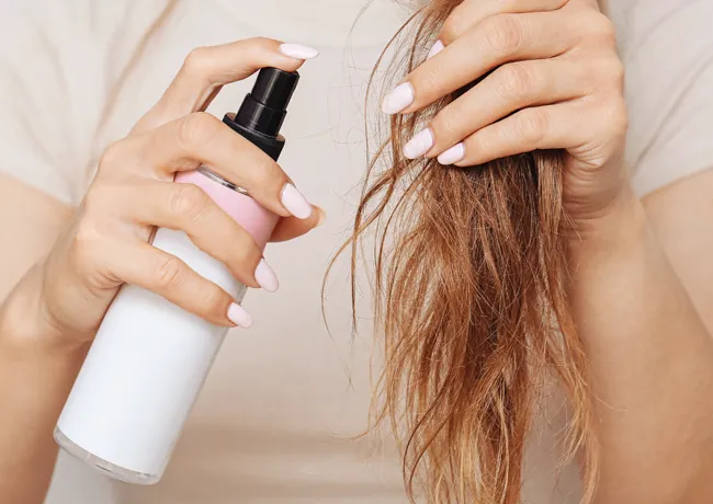 woman-spraying-hair