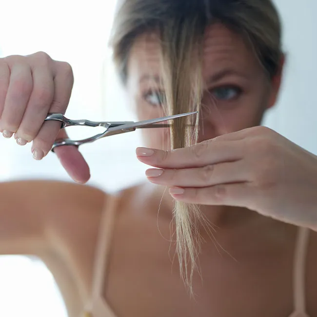 woman-cutting-her-bangs