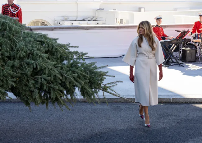 Melania Trump white coat red gloves welcomes White House Christmas tree 2025