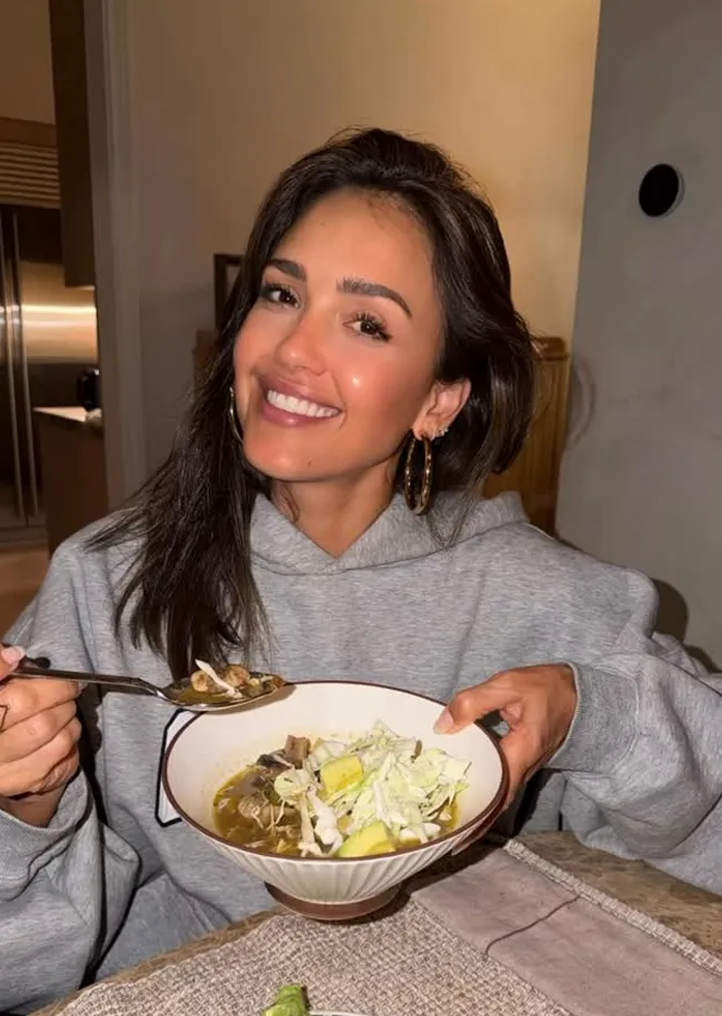 "Jessica Alba cooking pozole in a hoodie"