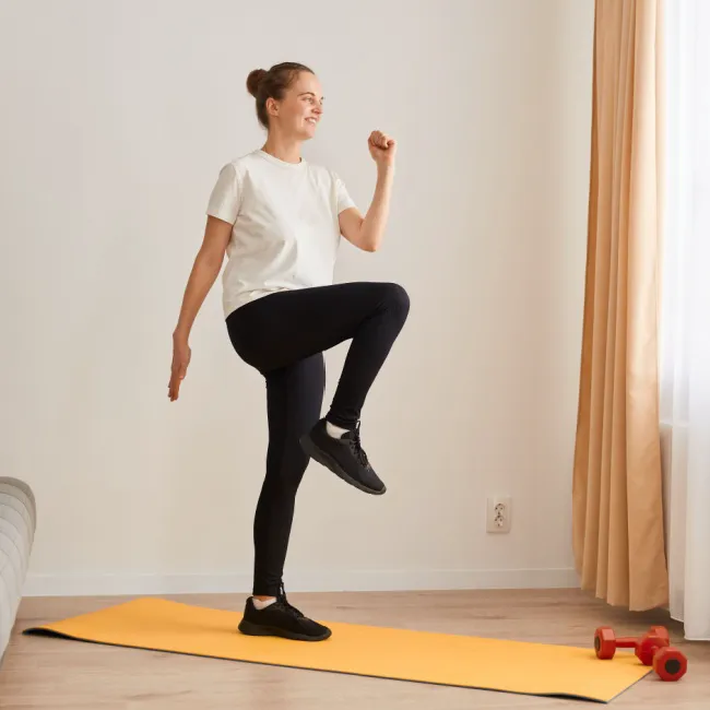 "Woman doing a curtsy step-up exercise"