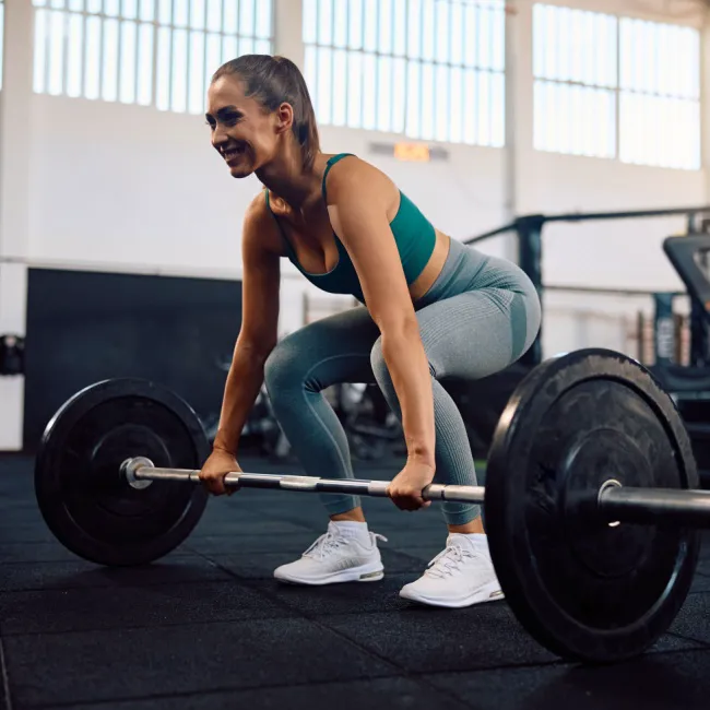 "Woman eating a healthy salad after a workout"