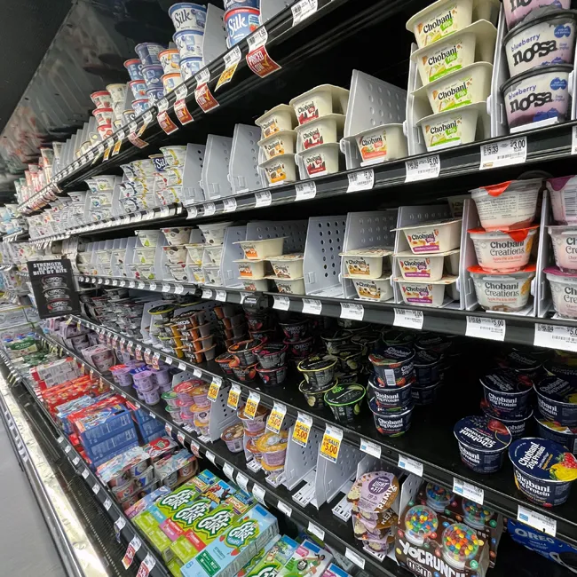Grocery store yogurt aisle with various low-sugar options.