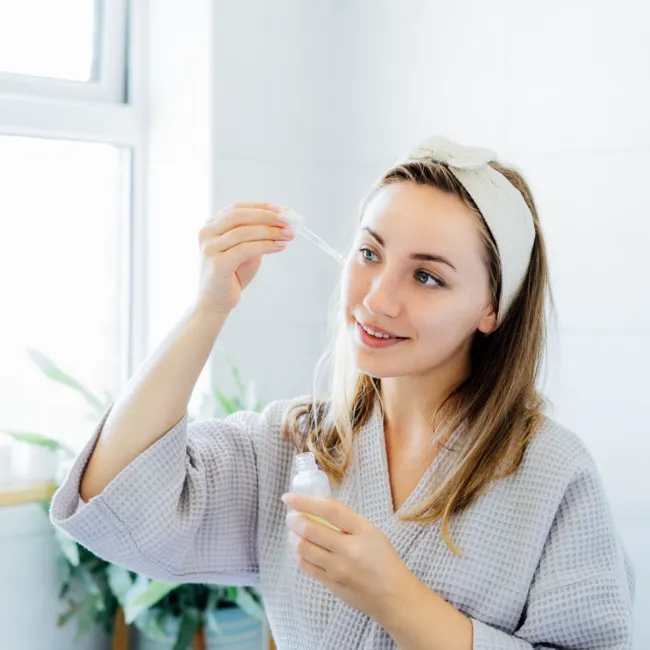 "Woman holding a skincare product"