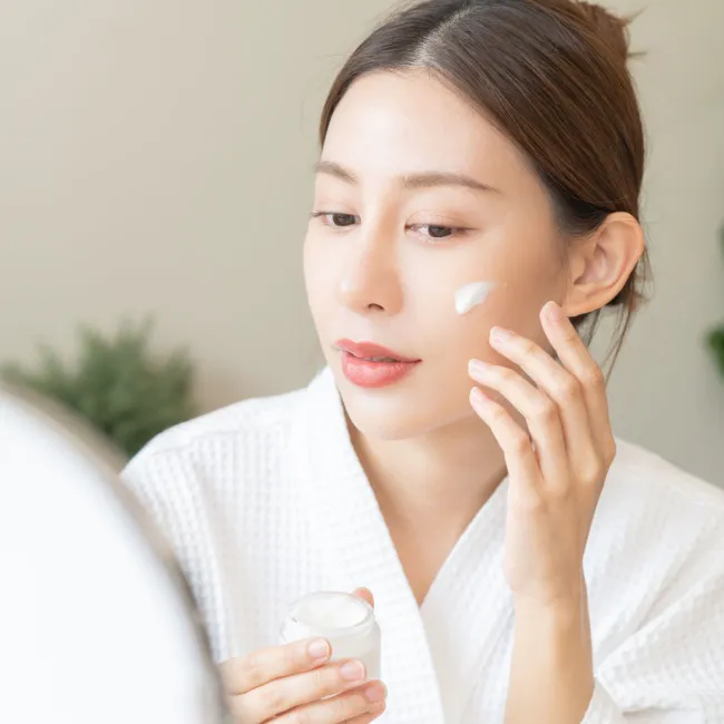 "Close-up of a woman's hand applying moisturizer"