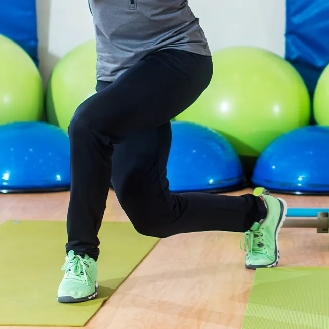 "Senior woman in sportswear exercising in a gym"