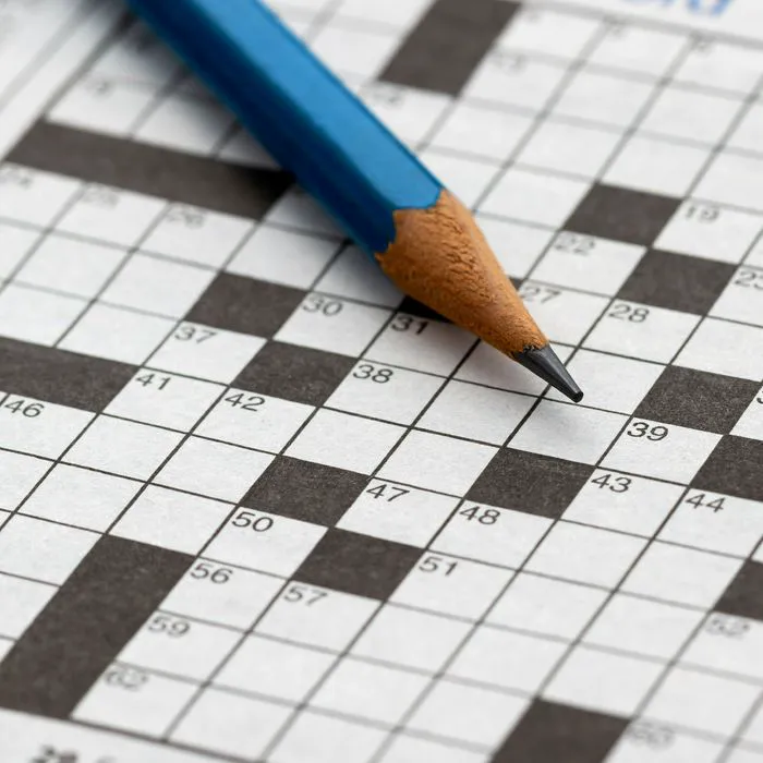 Crossword puzzle on a table, inviting mental challenge.