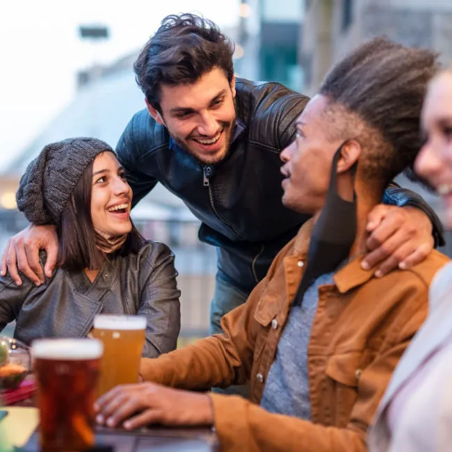 Friends laughing together, enjoying a joyful moment.