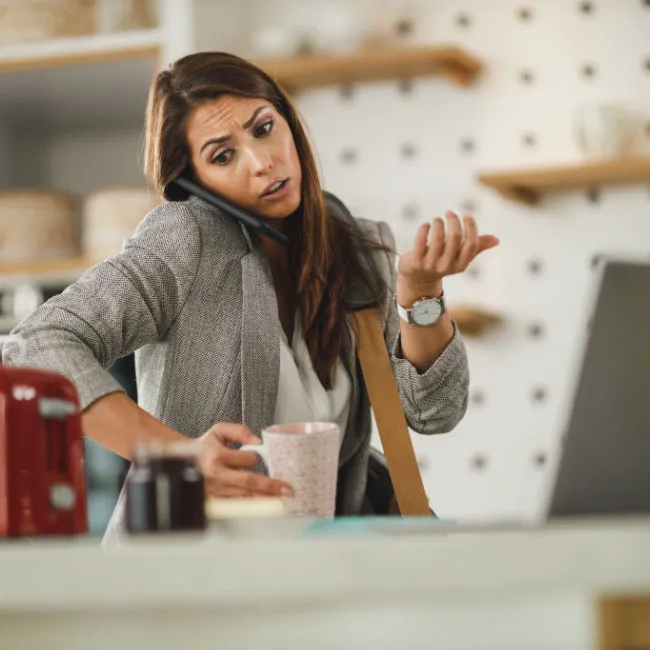 Woman multitasking, balancing work and personal tasks.