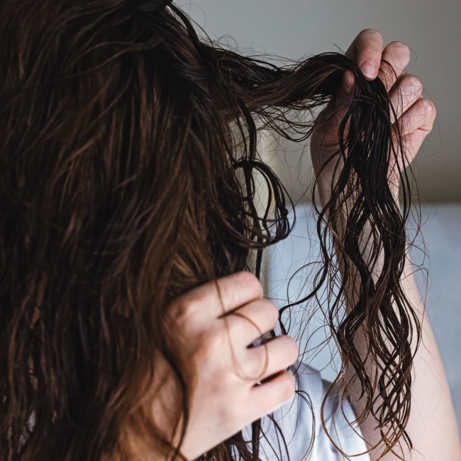 "Close-up of a middle-aged woman touching her face"