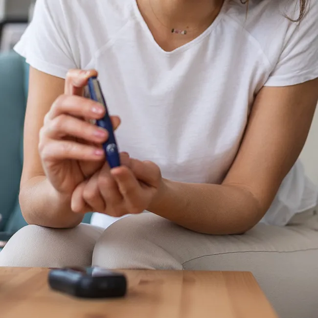 "Checking blood sugar level with a monitor"