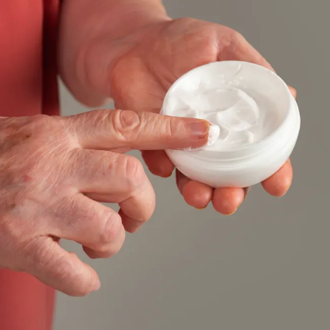 "Close-up of a woman's hands applying skincare"