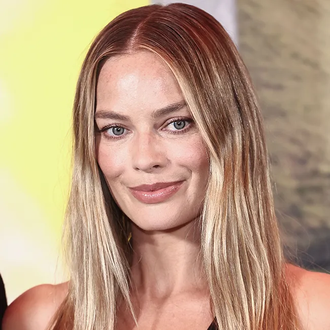 Margot Robbie at a photocall showcasing her bold style.