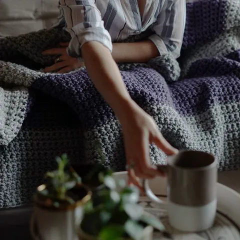 Woman enjoying tea to relax before bedtime.