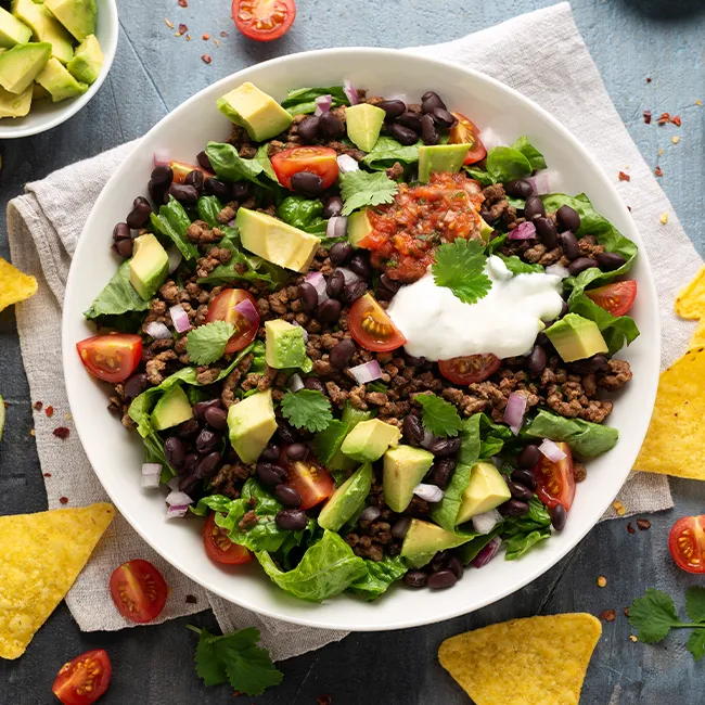 "Black bean taco salad bowl on a table"