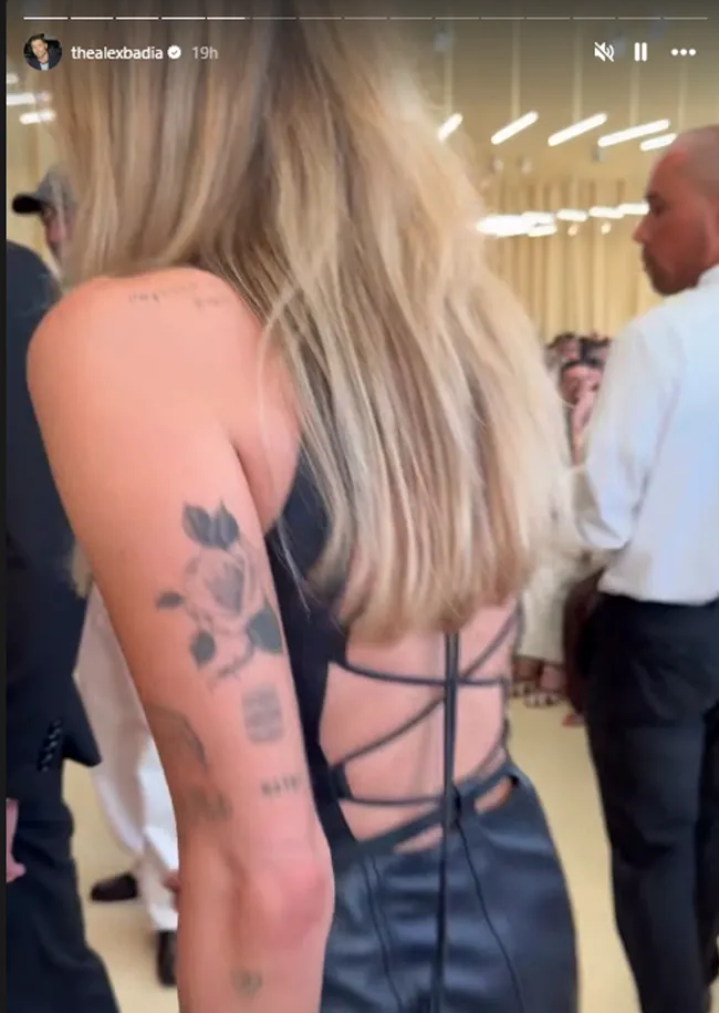 "Miley Cyrus showcasing her outfit at Hermes Fashion Show"
