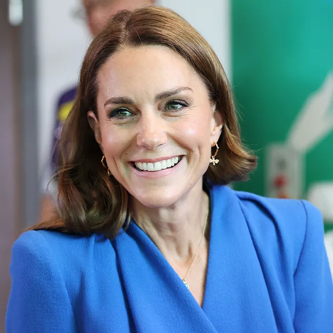 "Kate Middleton visiting cancer patients in a red and white heart-printed dress"