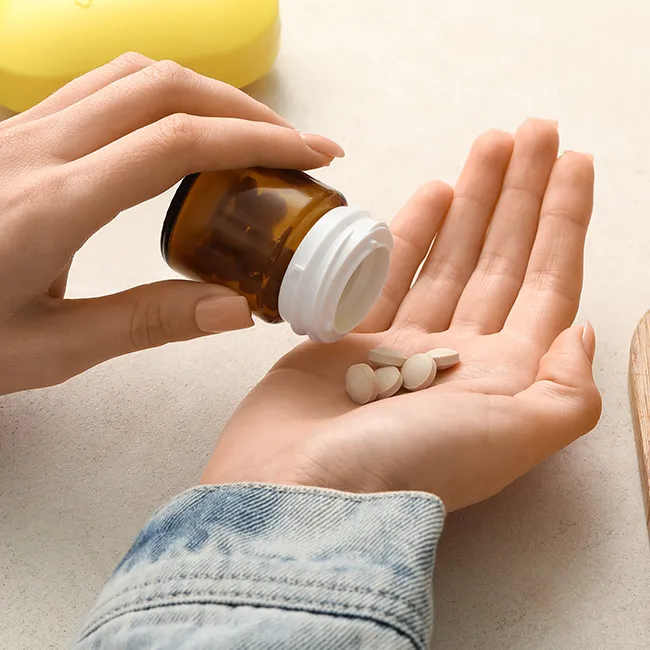 "Vitamin C pills being spilled into a hand"