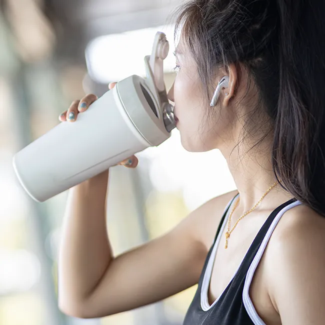 "Woman drinking protein drink"